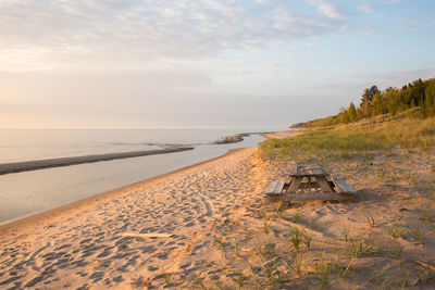 Scenic view of beach against sky during sunset