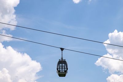 Low angle view of cable cabin against blue sky