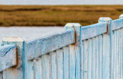 Close-up of wooden fence on field