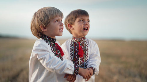 Portrait of smiling boy standing on field