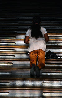 Rear view of a boy on steps