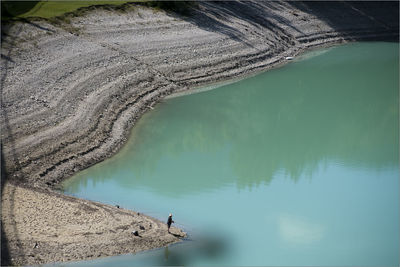 High angle view of man fishing in lake