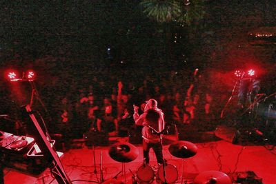 People playing guitar at music concert