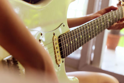 Close-up of hand playing guitar