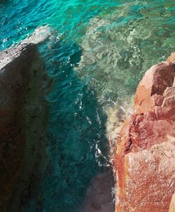 High angle view of rock by sea