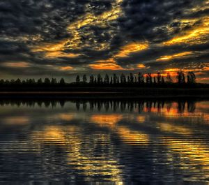 Scenic view of lake against orange sky