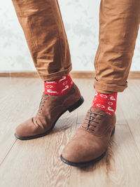 Young man in his chinos trousers, red socks with reindeer. scandinavian. christmas celebration.