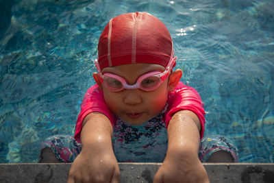 High angle portrait of girl in swimming pool