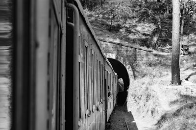 Toy train moving on mountain slope, beautiful view, one side mountain, one side valley moving fast