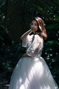 Portrait of a smiling young woman standing outdoors