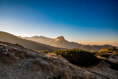 Scenic view of mountains against clear blue sky