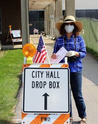 Woman in mask  on her way to vote