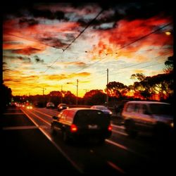 Cars on road at sunset