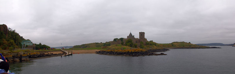 Panoramic view of sea and buildings against sky