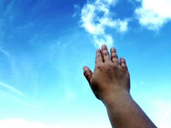 Low section of woman standing against cloudy sky