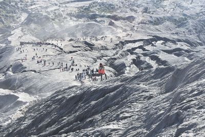 High angle view of people on mountain by sea