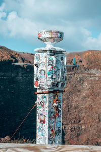 View of communications tower against cloudy sky