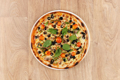 High angle view of pizza served on table