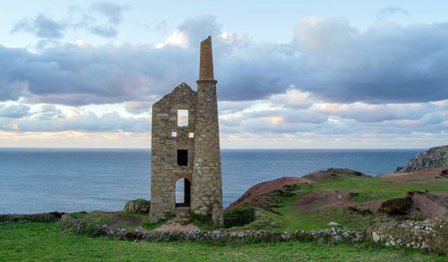 Castle by sea against sky