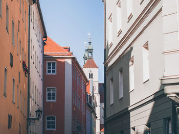 Low angle view of buildings in town against sky