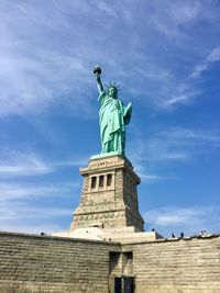 Low angle view of statue of liberty against sky