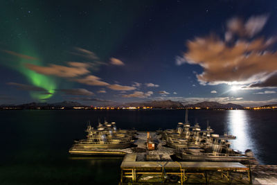 View of boats moored at harbor against sea and sky