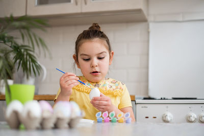 Portrait of cute girl playing with toys at home