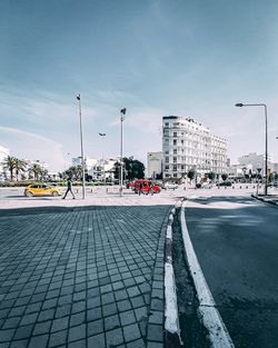 City street by buildings against sky