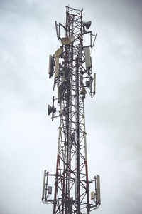 Low angle view of communications tower against sky