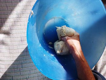 High angle view of man kneading dough in bowl