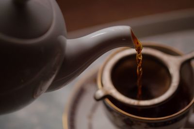 Close-up of pouring tea in cup