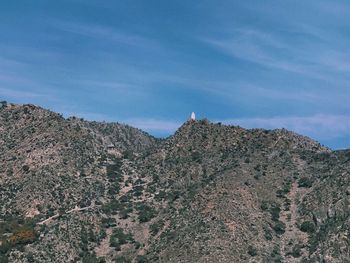 Low angle view of rocky mountain against sky