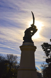 Statue of tree at sunset