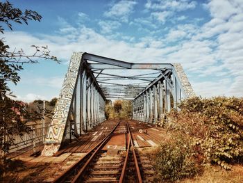 View of railroad tracks against cloudy sky