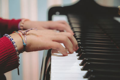 Midsection of woman playing piano