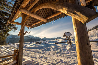 Scenic view of snow covered field against sky