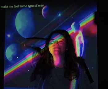 Woman dancing in illuminated nightclub