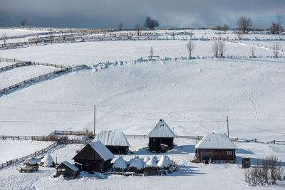 Houses on snow covered field