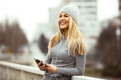 Young woman using mobile phone outdoors