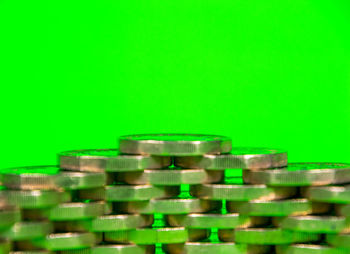 Close-up of stack of objects over green background