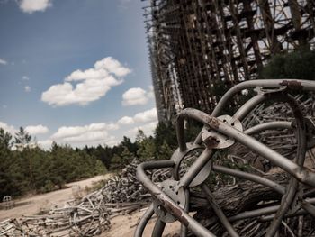 Abandoned bicycle on field against sky