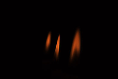 Close-up of burning fire against black background