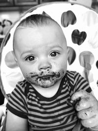 Close-up portrait of cute baby with messy face