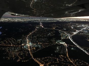 High angle view of illuminated cityscape against sky at night