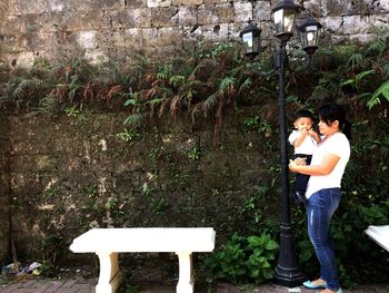 Couple standing by tree