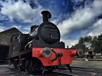 Railroad track against cloudy sky