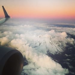 Aerial view of cloudscape over airplane wing