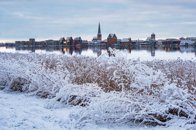 View of river with snow in city