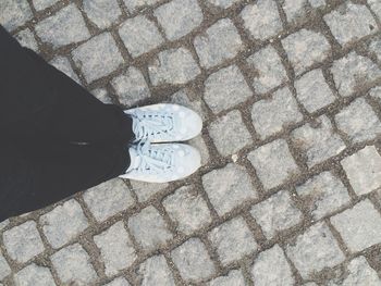 Low section of person standing on footpath