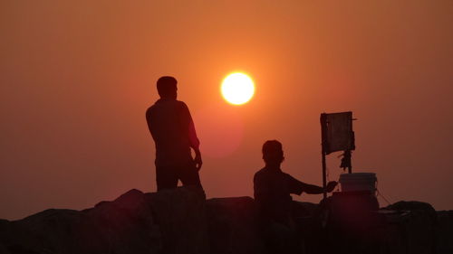 Silhouette of people at sunset